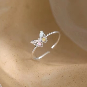 925 silver butterfly open ring with colorful zircon stones on beige matte background