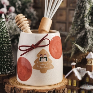 Christmas ceramic storage jar with red bow and merry christmas snowman label on wood base