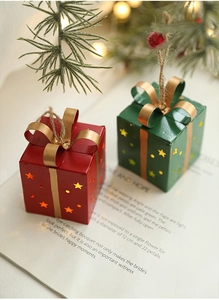 Gros plan sur des ornements de boîte cadeau de Noël en fer rouge et vert avec nœuds