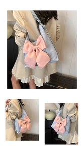 Three-way view of blue shoulder bag with large pink satin bow and silver chain strap