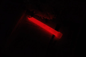 Macro shot of 6-inch red chemical glow stick showing high brightness in dark environments