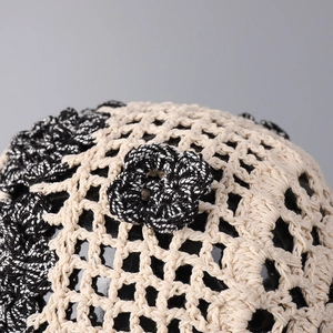 Close-up of handmade crochet flower detail and breathable mesh texture on a vintage hat