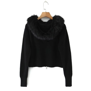 Detail of black knit cardigan with faux fur collar and small metal zipper closure