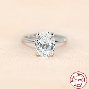 S925 sterling silver engagement ring featuring oval cut cubic zirconia in four-prong setting