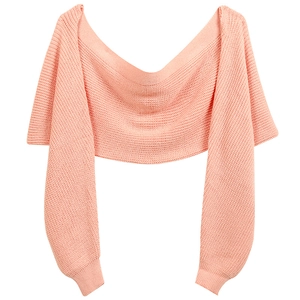 Detail of pink knitted wrap shawl with sleeves featuring soft ribbed texture and wide neckline