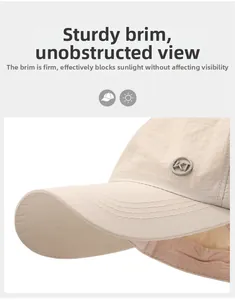 Detail of light beige sun visor hat with stiff brim and KT logo for outdoor UV protection