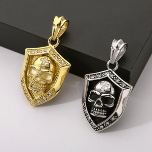 Macro view of gold and silver punk skull pendants with rhinestone cross detailing
