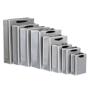 Gray paper gift bags set with black handles and white edges in eight various sizes