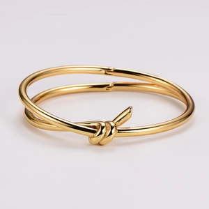 Polished golden knot hinge bracelet with minimalist modern design for women