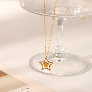 Double-layered gold star pendant necklace with crystal inlay on a delicate chain