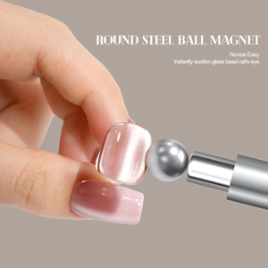 Macro shot of powerful double-ended magnet tool for cat eye nail art with silver metallic finish