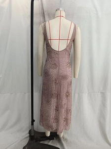 Close-up of pink sequined midi dress featuring intricate beaded floral embroidery