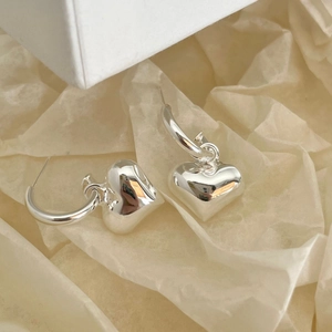 Polished 925 sterling silver heart hoop earrings displayed on a minimalist gift box