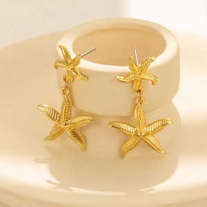 Elegant 18K gold-plated stainless steel double starfish drop earrings on ceramic stand