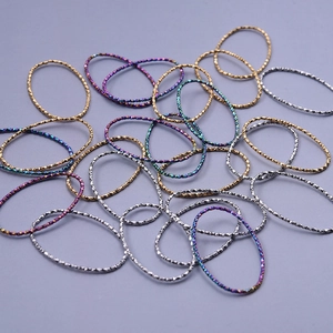 Detailed view of 304 stainless steel geometric rings with textured diamond cut finish