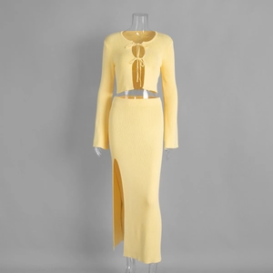 Detail of yellow knit two-piece set featuring a tie-front cardigan and side slit maxi skirt