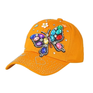 Bright orange women's sun hat featuring a colorful rhinestone butterfly and silver studs