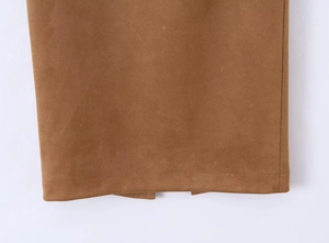 Close-up of split hem stitching and faux suede texture on a mid-length brown skirt