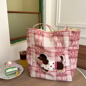 Detail of pink plaid canvas tote bag featuring a 3D dachshund towel embroidery patch