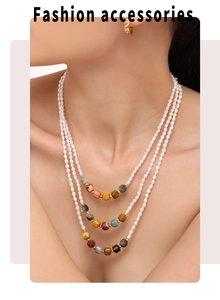 Detailed close-up of a three-layer necklace with freshwater pearls and multi-colored beads