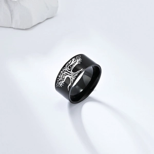 Gros plan sur une bague en titane noir avec gravure argentée de l'arbre de vie sur blanc