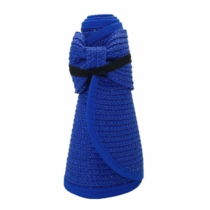 Detail of blue woven sun hat in rolled-up state with black elastic bow for easy storage
