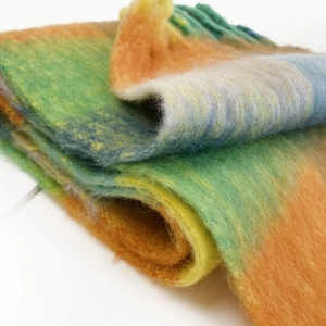 Macro detail of multicolored striped mohair scarf showing thick textured fabric and soft fibers
