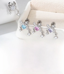 Detailed view of silver bow-knot stud earrings set with colorful zircon stones