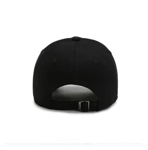 Detail view of the black cotton baseball cap showing adjustable bronze metal buckle strap