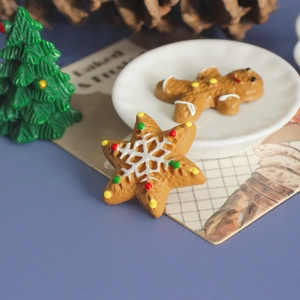 Macro shot of resin gingerbread man and star decorations for DIY Christmas crafts
