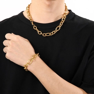 Detailed close-up of a bold gold stainless steel chunky link necklace and bracelet set