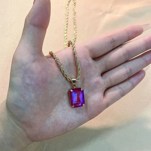 Gold twist chain necklace with a rectangle magenta gemstone pendant in four-prong setting