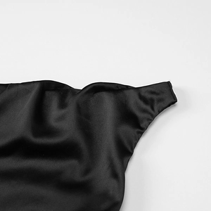 Detail of premium black satin fabric showing elegant drapes and smooth silky texture