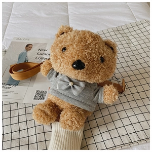 Detail of plush brown teddy bear bag with grey hoodie, bow accent and pearl detail