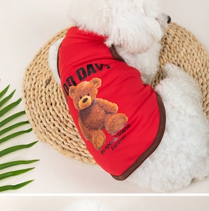 Detail of breathable red mesh pet vest with teddy bear print on a white dog