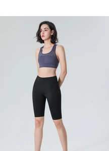 Detail of high-waisted black yoga shorts and grey-purple breathable sports bra set