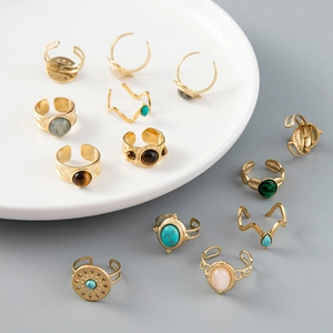Detail shot of vintage bohemian gold rings set with turquoise and varied semi-precious gems
