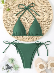 Dark green ribbed triangle bikini set with halter ties and side tie bottoms flat lay