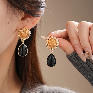 Vintage flower earrings with gold hollow rose and black teardrop pendant design
