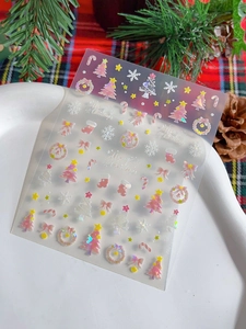 Macro shot of iridescent Christmas nail stickers with snowflakes and festive trees motifs