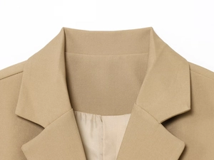 Macro view of notch lapel and fine twill texture on khaki tailored blazer jacket
