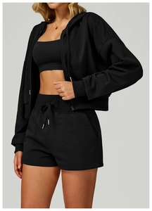 Detail of black sports hoodie fabric texture with drawstring shorts and ribbed cuffs