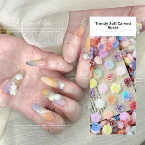 Macro view of 3D resin flower nail charms in various pastel colors for manicure design