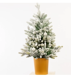 Close-up of 4cm flocked Christmas tree with silver ball and star ornaments in a gold pot
