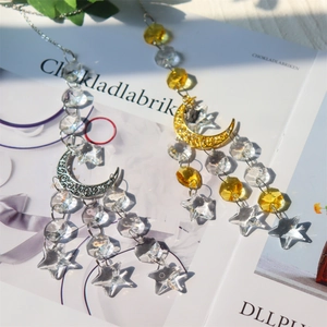Detail of bohemian suncatcher crystal prisms with gold and silver moon and star charms