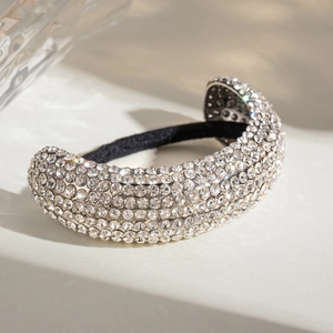 Macro detail of elastic hair tie with silver base and sparkling rhinestones on marble