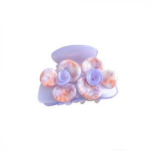 Elegant purple camellia acetate hair claw clip with pink floral design on white background