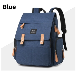 Detailed side view of the blue large capacity diaper backpack with leather zipper tabs