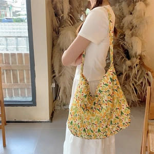 Detailed side view of large canvas shoulder bag with vibrant yellow citrus lemon prints