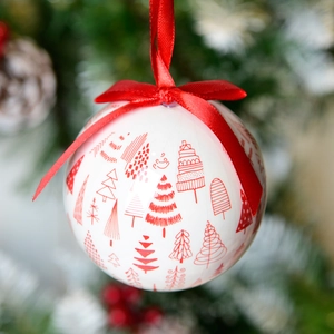White Christmas foam ball with red tree print and a decorative red silk ribbon bow